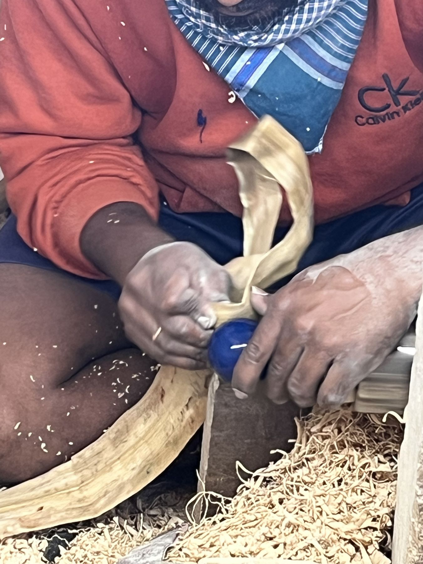 An Etikoppaka artisan turning a lacquered wooden bead on the lathe