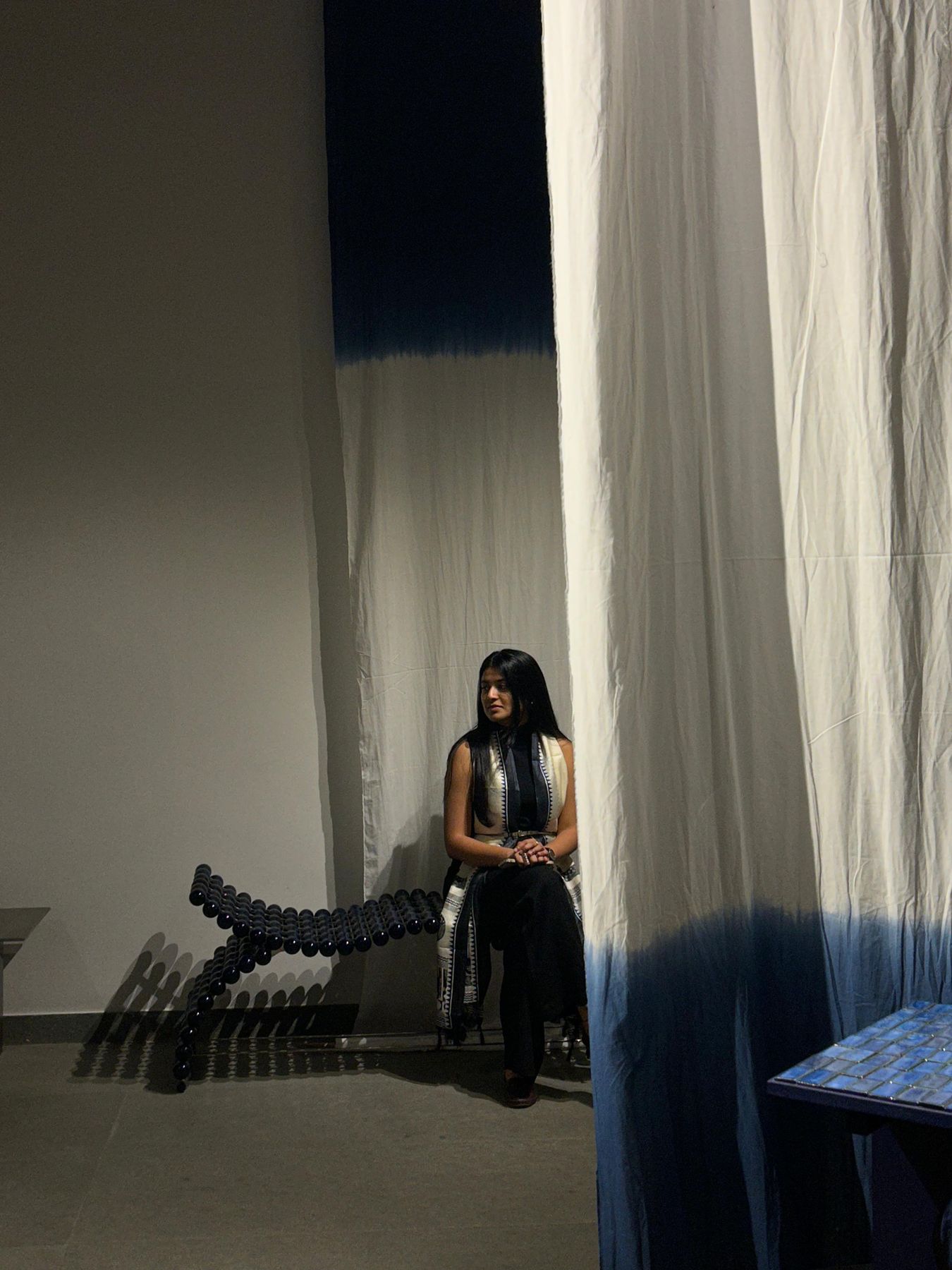 Palak Chaudhary, founder and chief designer, seated on a Zevar piece