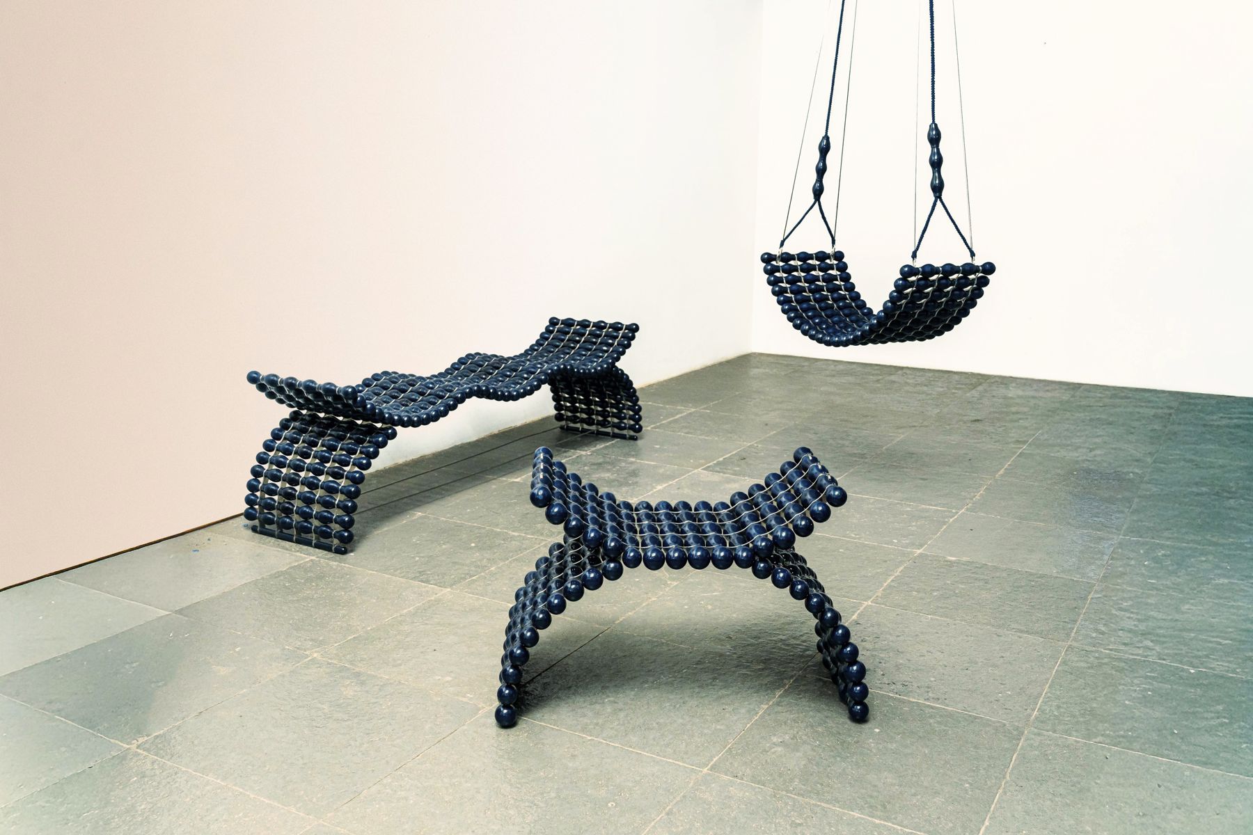 The Zevar collection — wave bench, flip seat and swing in lacquered wood and stainless steel